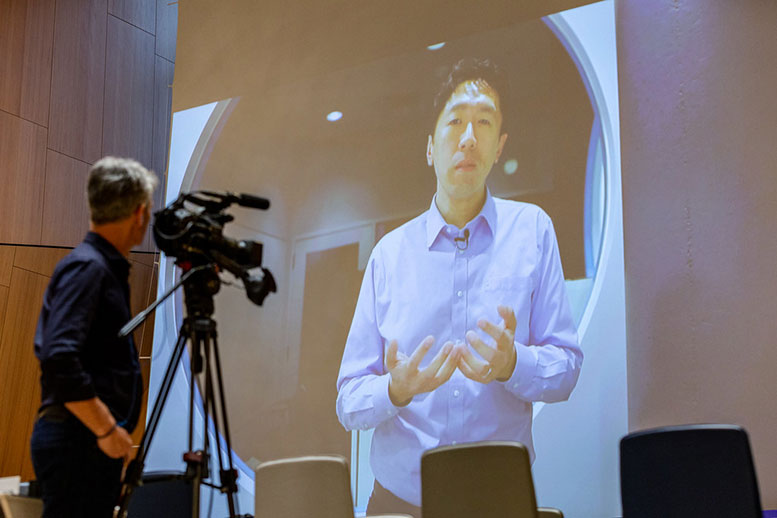 Andrew Ng projected in a wall during a video conference